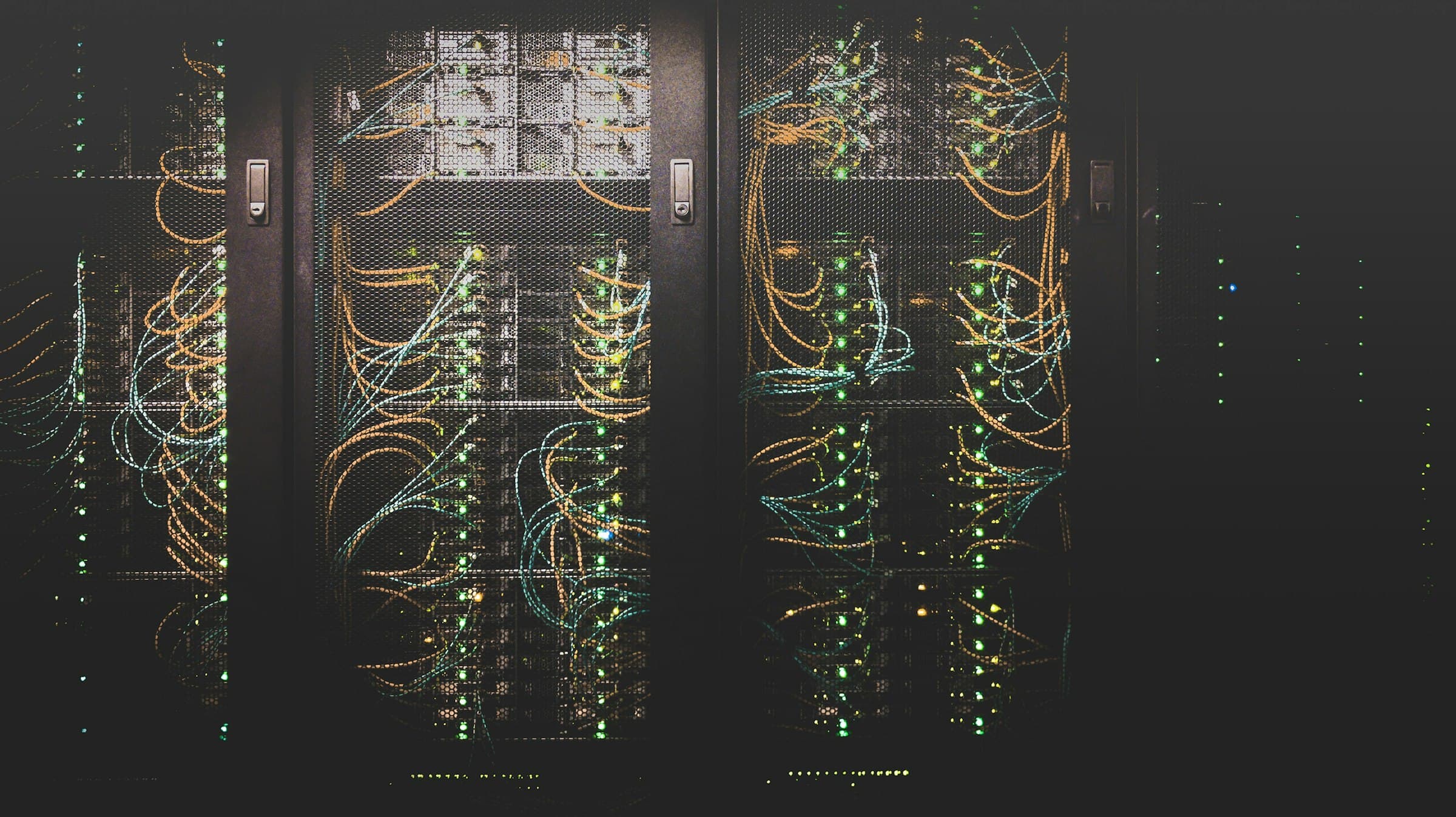 Equipment racks with fibre patch runs and rows of lit link indicators.