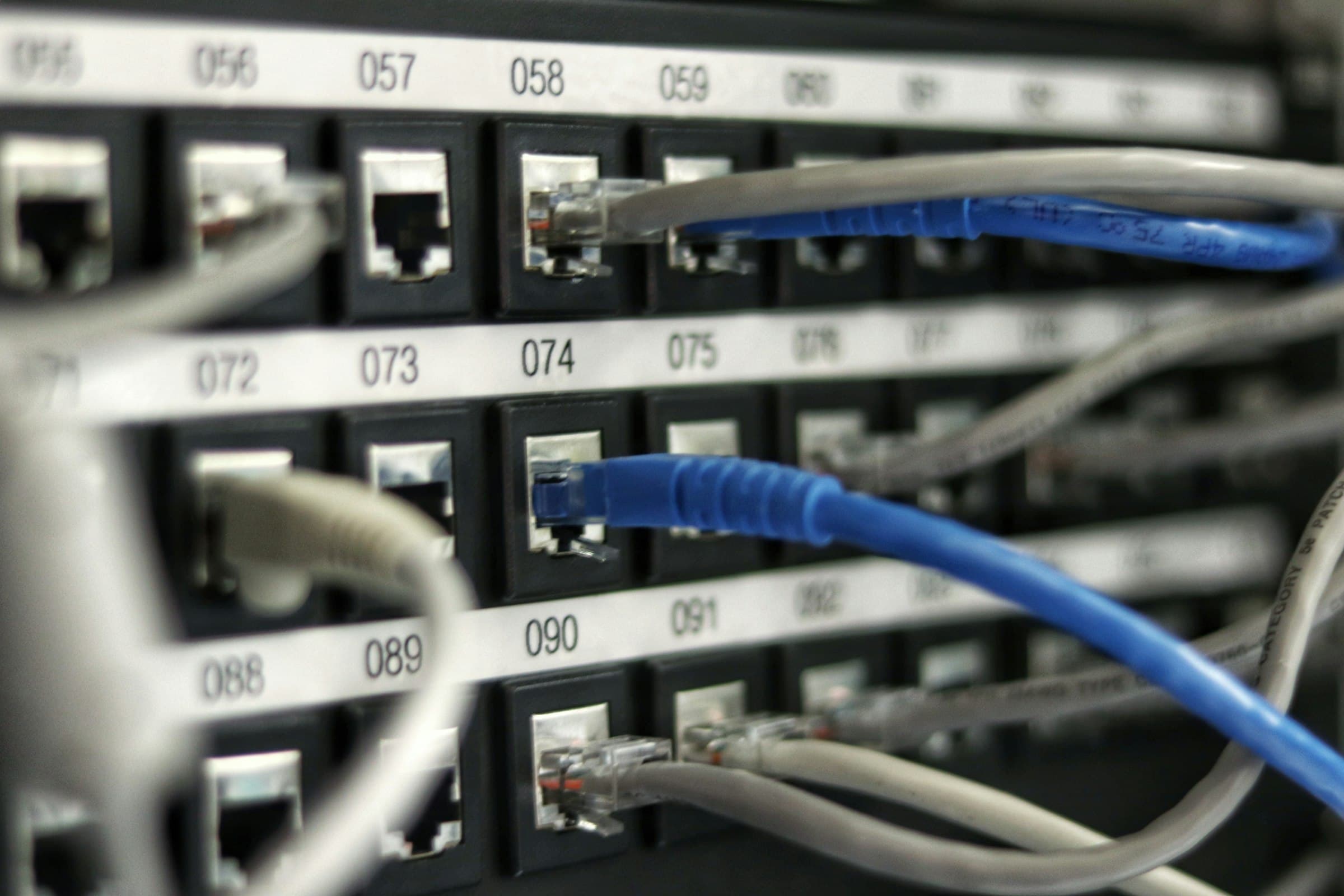 A copper patch panel with numbered ports and terminated cable dressed into the frame.